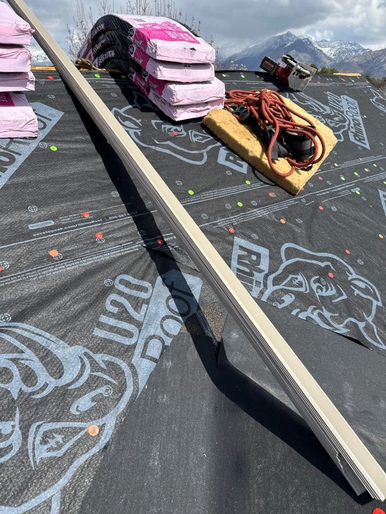 Rooftek worker applying weatherproof sealant to a roof in American Fork, UT